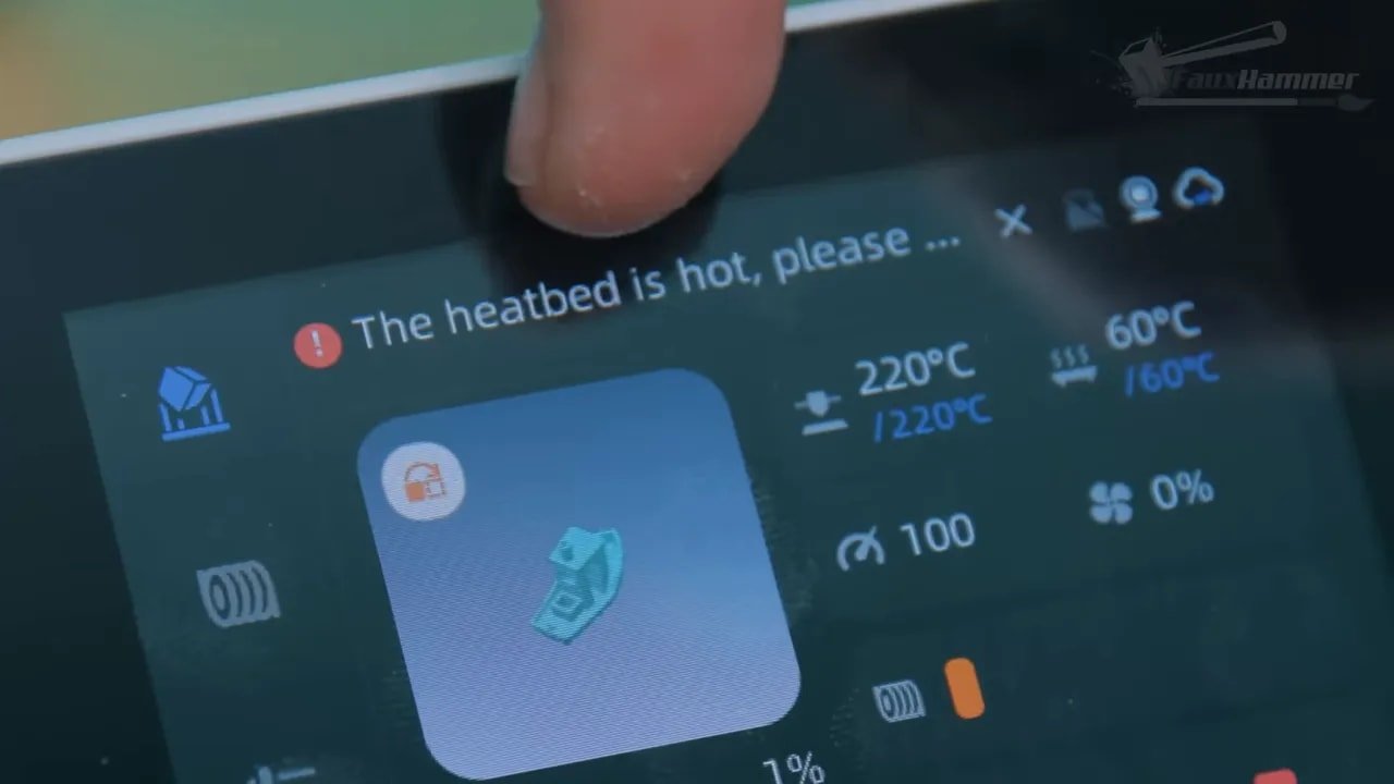 Close-up of Anycubic Kobra X touchscreen showing the “heatbed is hot, please…” warning