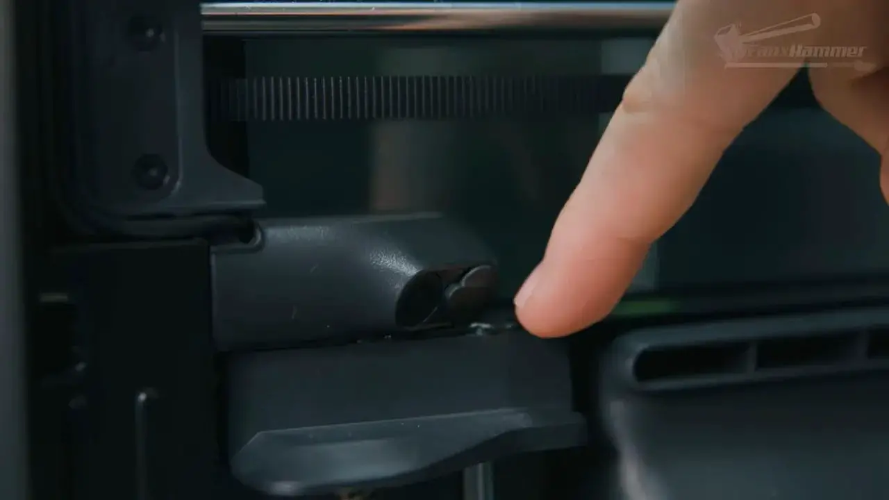 Hand adjusting the Bambu X2D camera privacy filter flap for remote monitoring
