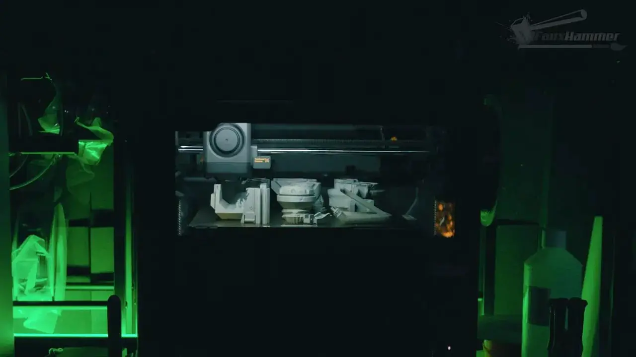 Bambu X2D printer chamber showing the toolhead and dual-nozzle system during a multi-material print