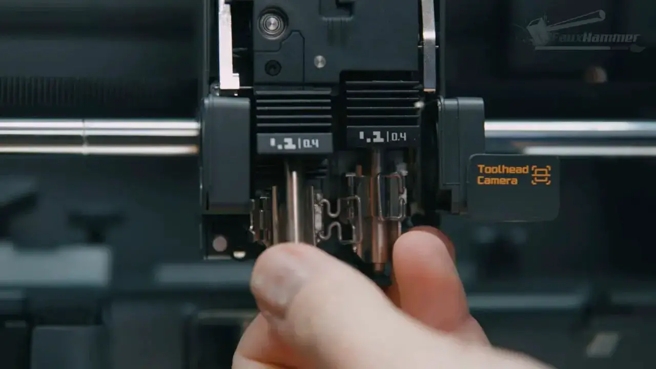 Close-up of the Bambu X2D toolhead showing internal dual-nozzle components
