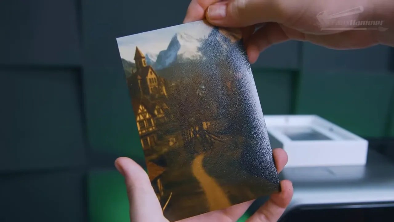 Hand holding a finished UV resin print panel in front of the EufyMake E1