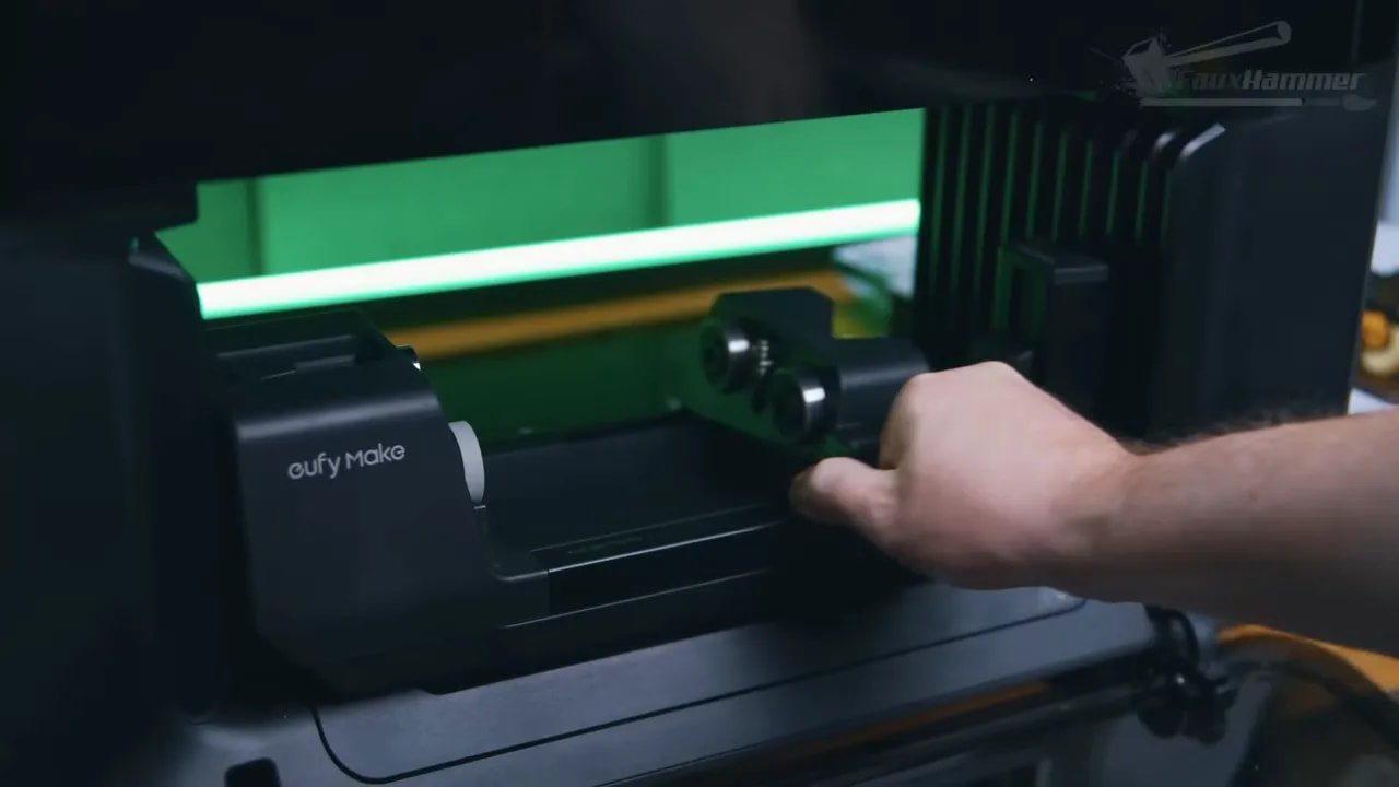 Close-up of the EufyMake E1 rotary attachment being positioned by hand