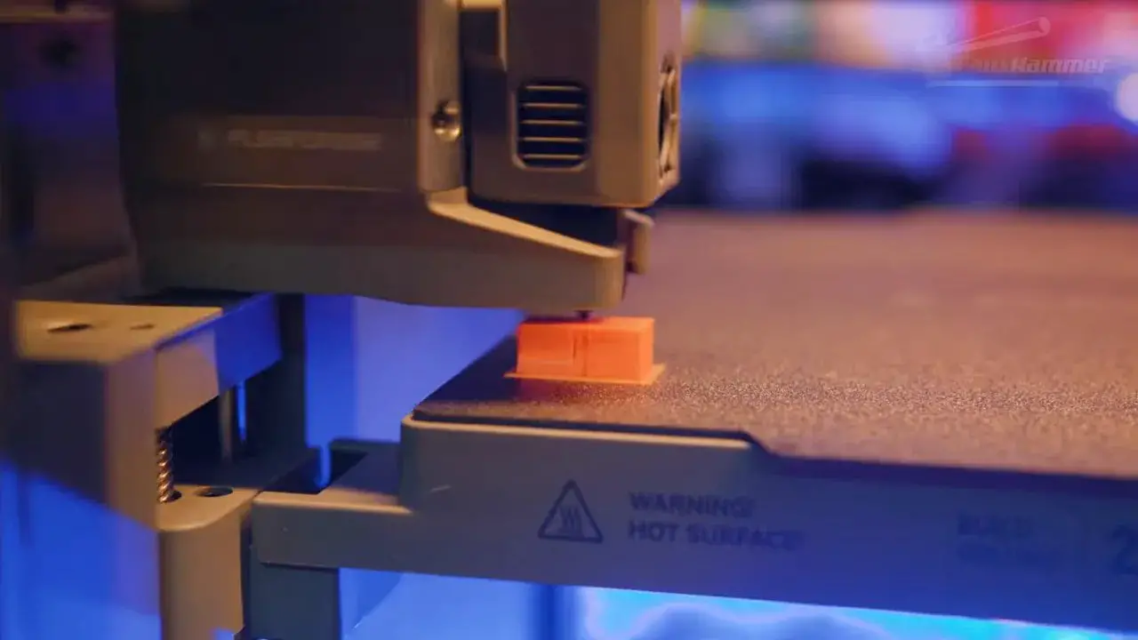 FlashForge Creator 5 printing process with an orange part on the build plate