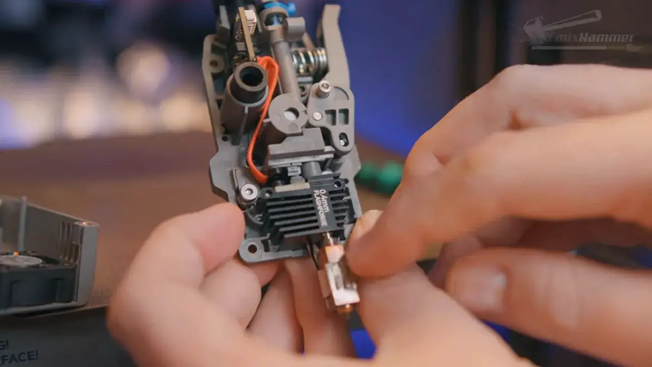 Close-up of FlashForge Creator 5 toolhead being serviced with nozzle area exposed