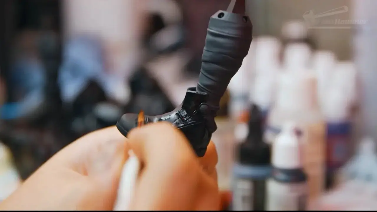 Gloved hands adjusting or handling resin printer hardware in a workshop