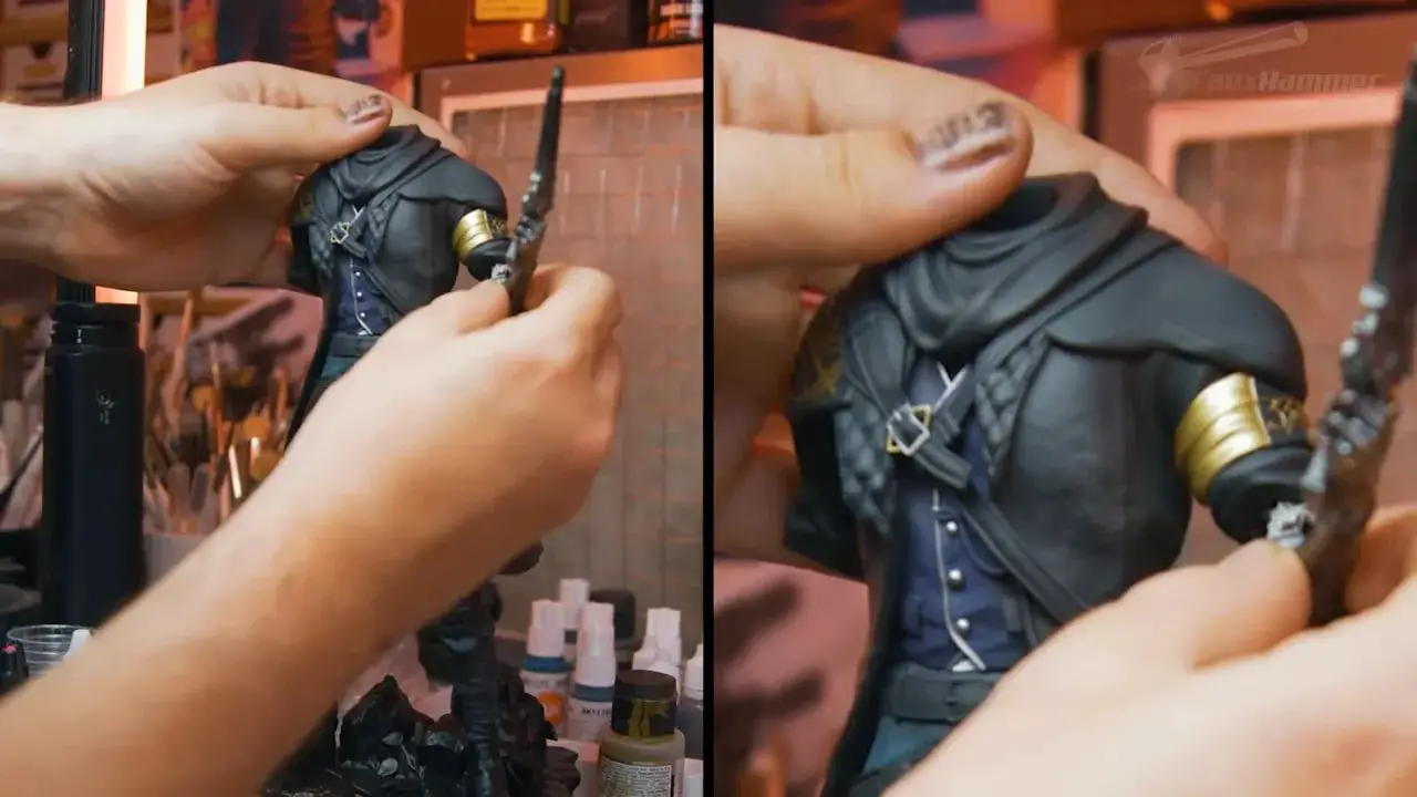 Close-up of hands positioning a painted miniature figurine for viewing