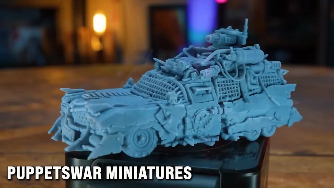 Detailed blue resin vehicle miniature showing crisp mechanical surface texture on a base