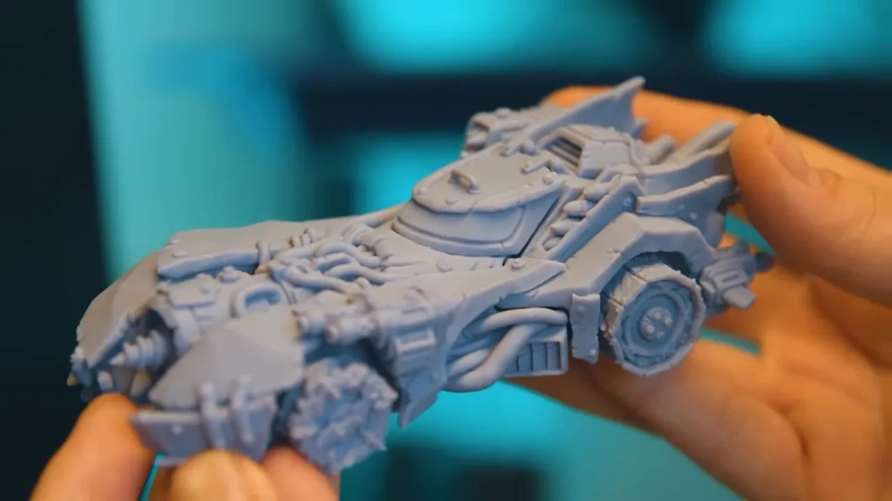 Vehicle miniature resin print with fine mechanical details held in hand