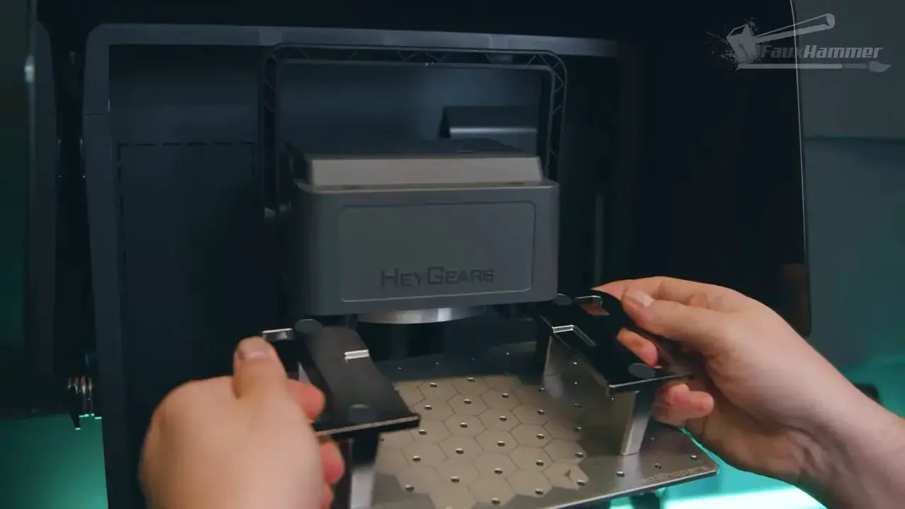 Hands installing or adjusting the build plate on a HeyGears Reflex 2 resin printer