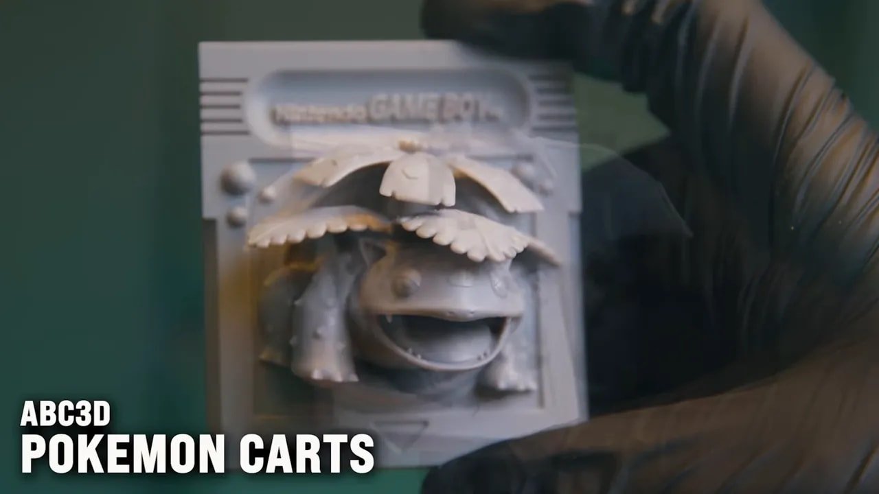 Hand opening a box to show a finished Pokemon cart miniature model