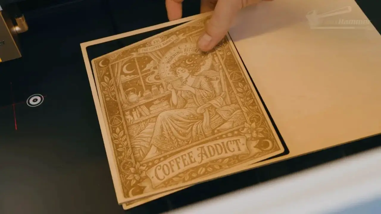 Engraved decorative card reading 'The Coffee Addict' placed on the LaserPecker LX2 work area
