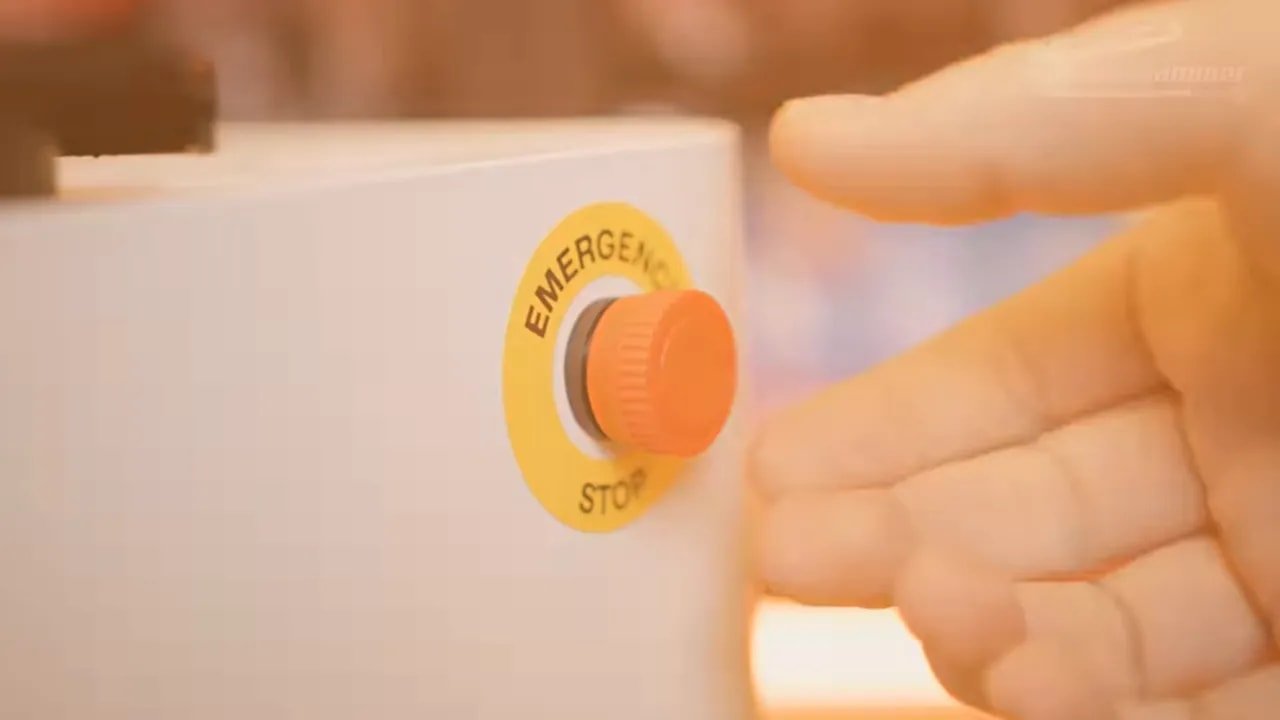 Close-up of the LaserPecker LX2 emergency stop key and stop control on the enclosure