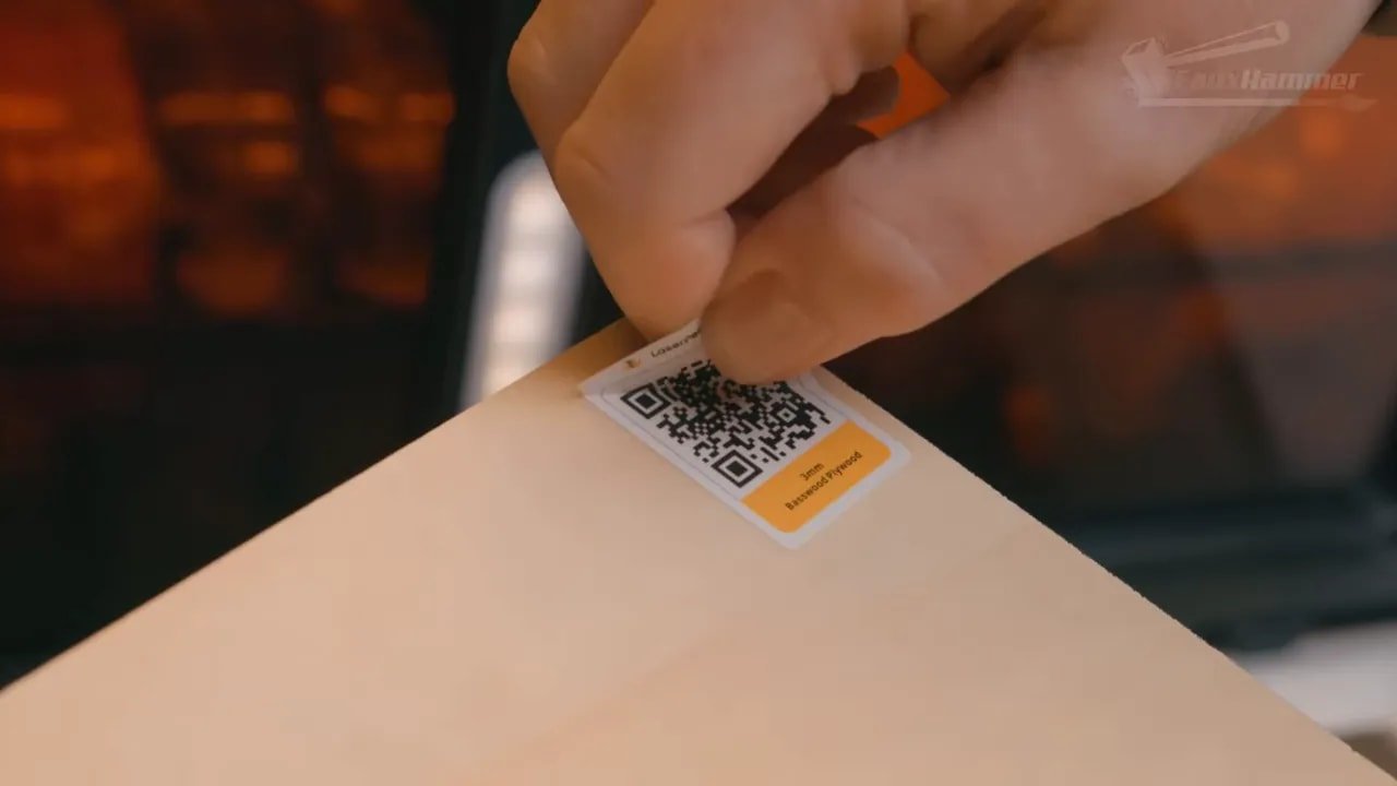 Close-up of QR code on a LaserPecker material label being scanned by a hand