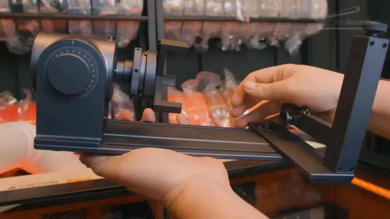 Rotary tool placement guide on the LaserPecker LX2 with hands aligning the fixture