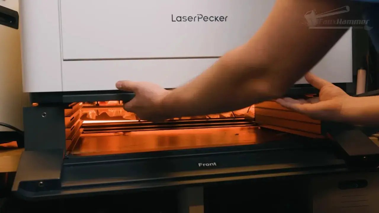 LaserPecker LX2 rotary accessory being installed inside the enclosure