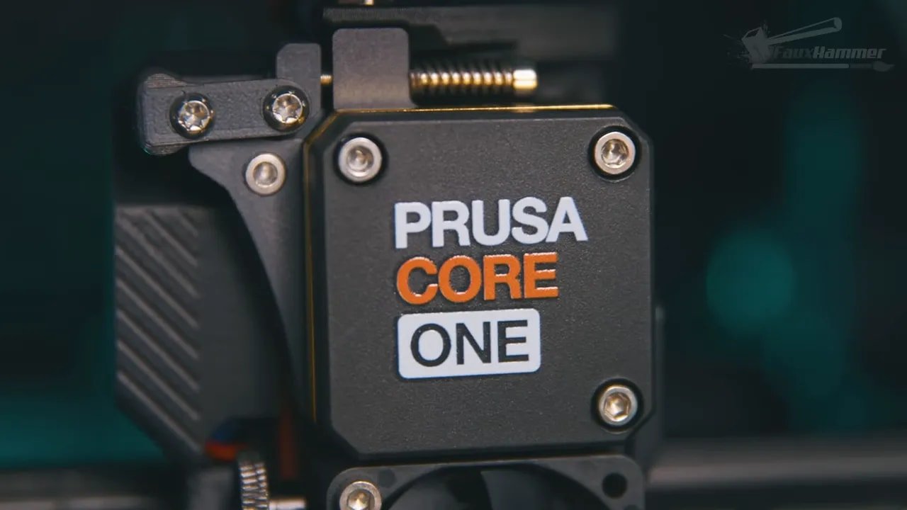 Prusa Core One close-up showing the “Prusa Core One” branding on the hotend assembly