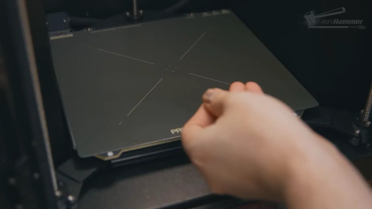 Close-up of inserting a Prusa Core One build plate in the enclosure