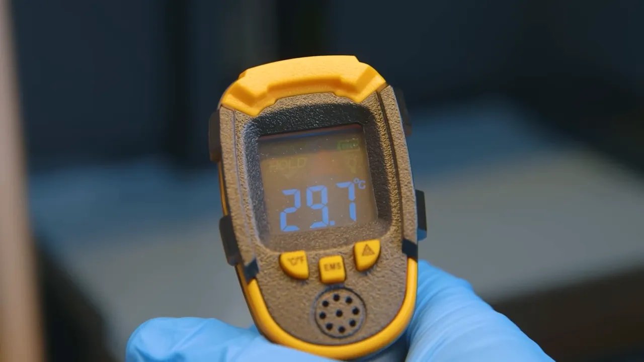 Infrared thermometer display showing 23.7°C during resin printing setup