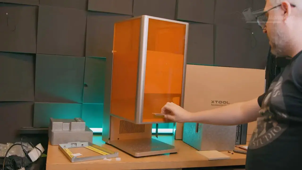 Reviewer lifting the xTool F2 Ultra UV from its box during unboxing