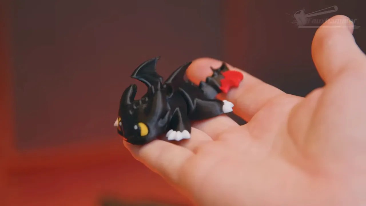 Close-up of a multi-colour dragon figurine held in a hand