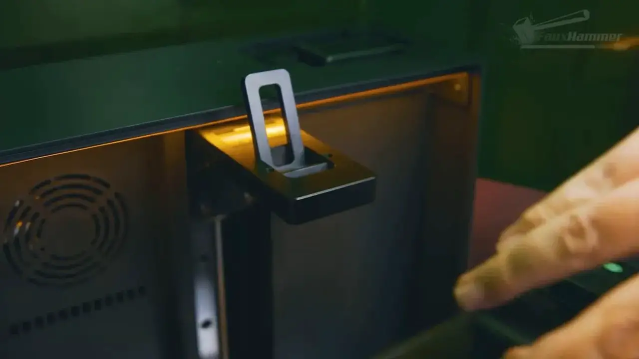 Close-up view of the Uniformation GK3 build plate mounting and latch area
