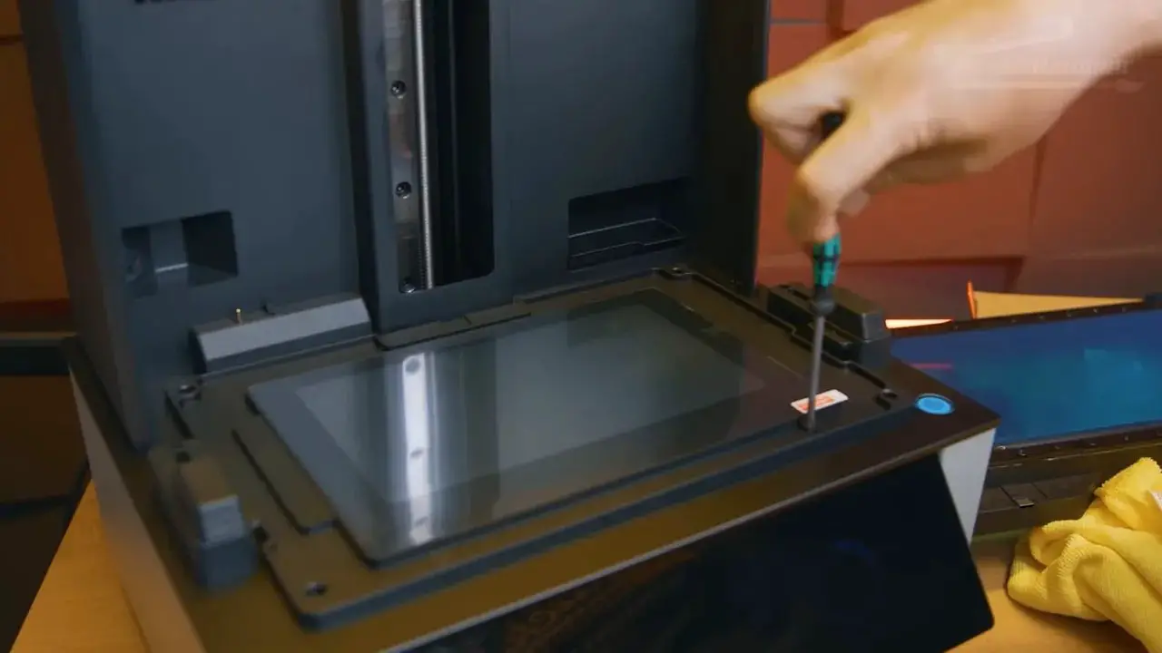 Hand reaching into the opened Uniformation GK3 LCD screen area for a fast replacement