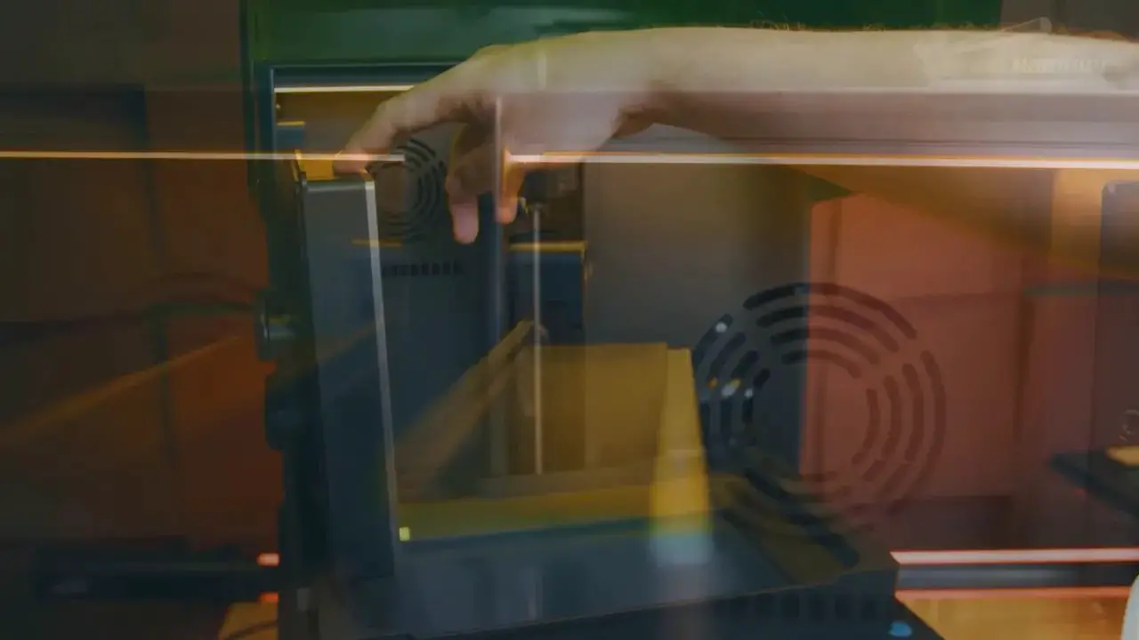 Uniformation GK3 lid open with hand accessing the resin vat area