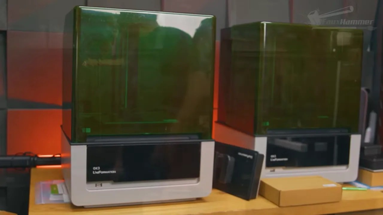 Uniformation GK3 printers side by side on a workbench with lids open