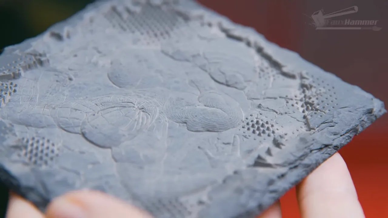 Close-up of detailed laser engraving on material surface with textured burn marks
