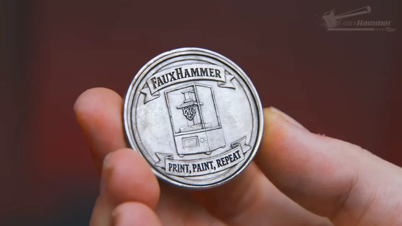 Hand holding an engraved coin-style print from the xTool laser